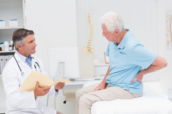 doctor with patient suffering from back pain